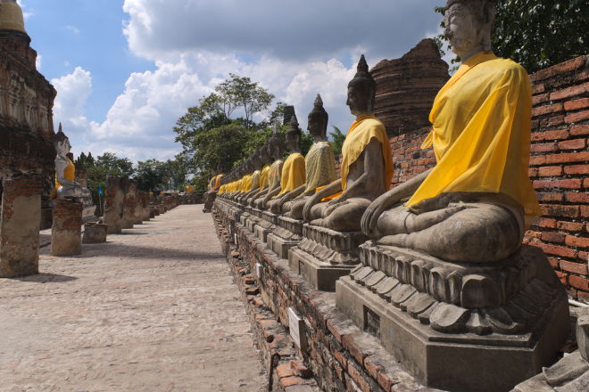 Buddha statues dressed in saffron cloth